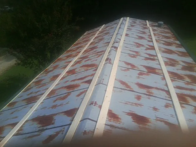 Rusted metal roof panels with new wood purlins before replacement — Storm Damage Roof Repair in Mahanoy City by Roofing Brothers