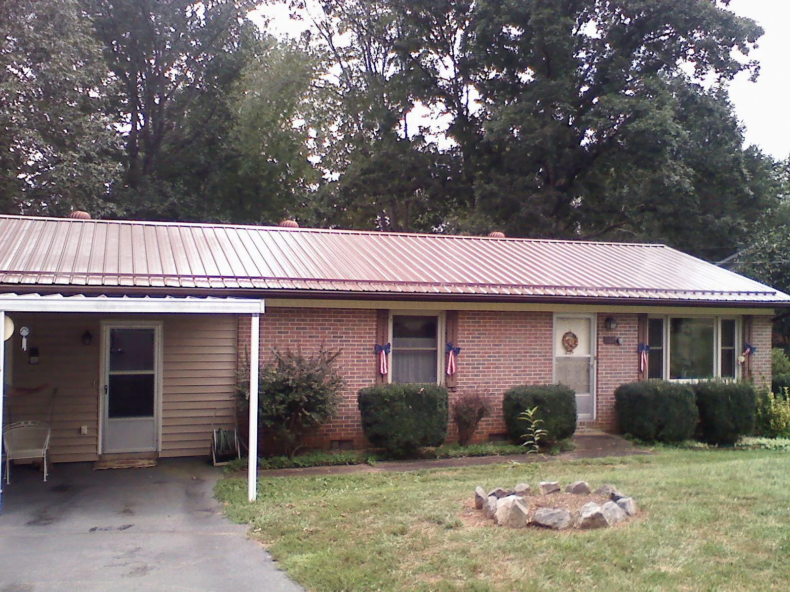 Bronze metal roof and carport on a brick ranch home — Roof Repair work by our crew in Mahanoy City