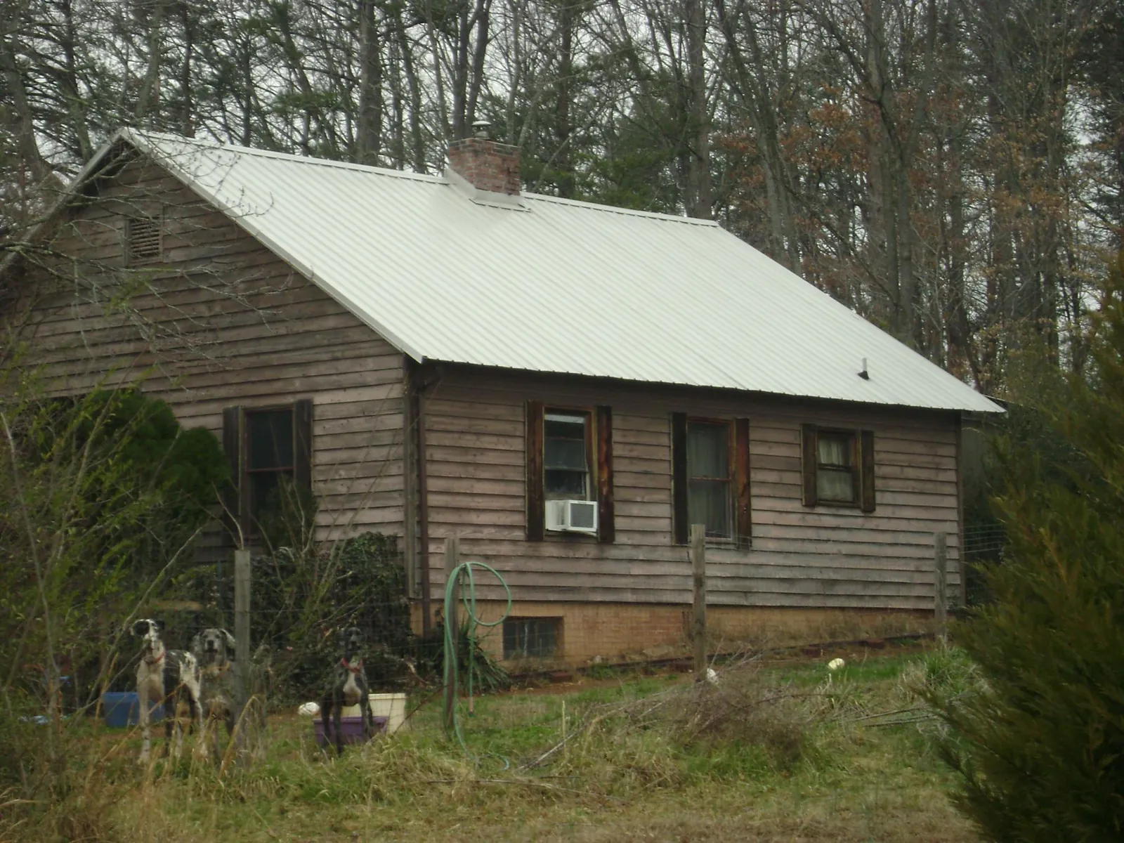 White metal roof on an old wood sided farmhouse, from a Asphalt Shingle Roof Repair job in Mahanoy City